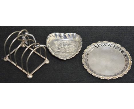 A small silver toast rack, Birmingham;  a silver heart shaped trinket dish decorated with cherubs, Birmingham;  another, Ches