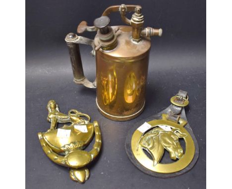 A Victorian brass door knocker, as an urn surmounted with a gryphon;a Burmex brass cylinder can;  a horse brass (3) 