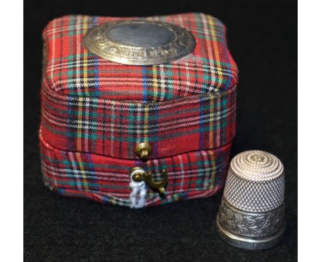 A sterling thimble in a silver mounted tartan box