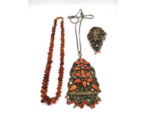 A vintage Baltic amber pebble bead necklace, a filigree and wirework coral bead brooch with a bird on a nest among foliage an