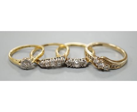 Three assorted 18ct and diamond set rings, including illusion set solitaire, three stone and graduated five stone, gross weig