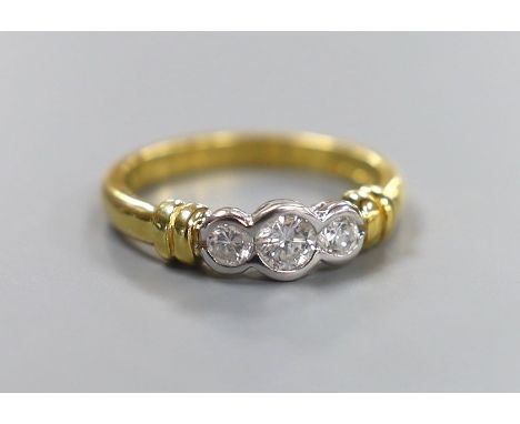 A modern 18ct gold and collet set three stone diamond ring, size O, gross weight 4.6 grams, total diamond weight approx. 0.50