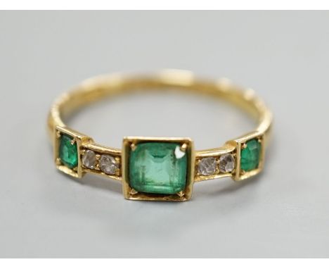 A George V 18ct gold, three stone emerald and four stone diamond chip set half hoop ring, size L, gross weight 1.8 grams.