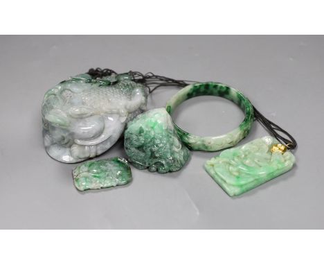 A group of five Chinese jadeite carvings, including two pendants and a bangle, largest 11cms long