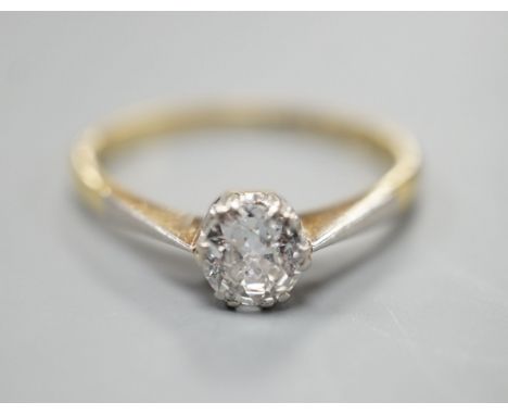 An 18ct gold and platinum solitaire diamond ring, the brilliant cut stone approximately 0.35cts, size M, gross 2.5 grams