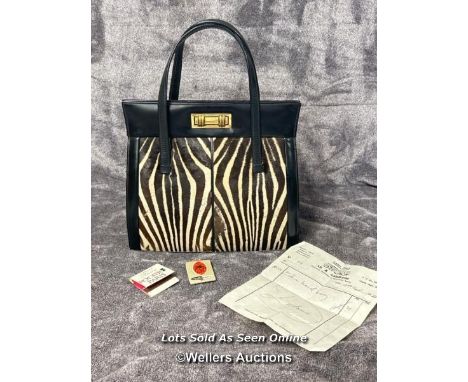 A vintage Zebra skin handbag with original receipt dated 19th September 1966 and two vintage matchbooks from Marie Claire Rod