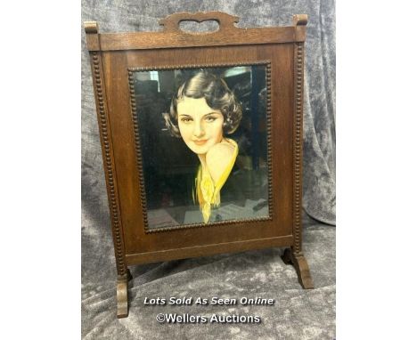 A vintage oak fire screen with glazed print of a 1920's lady, 54.5 x 76cm 