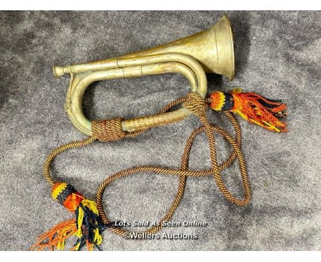 A brass military bugle with wool chord, 27.5cm long / AN12 