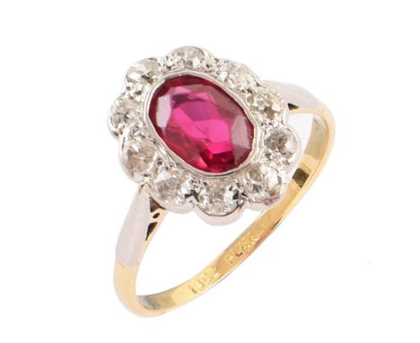 Synthetic Ruby and diamond cluster 18ct gold ring , the oval mixed cut ruby weighing approximately 1 carat, white rubover set