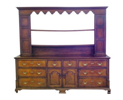 George III oak dresser, top section with dentil mould above shaped cornice, two three panel doors flanking two fixed plate sh