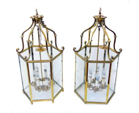 A pair of brass Regency style hall lanterns, each with scrolling supports to top and six light suspension loop, height approx