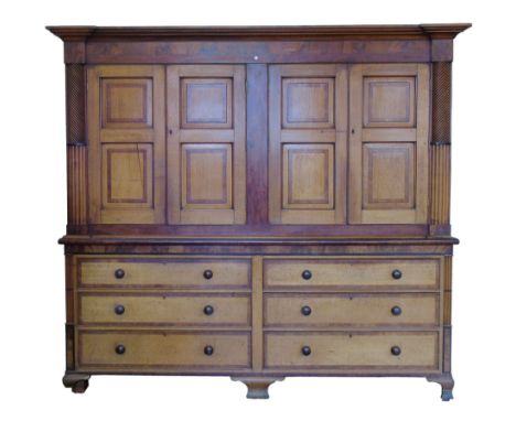 Early 19th century oak housekeepers cupboards, top section with four two panelled doors with raised and fielded mahogany cros