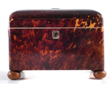 Tortoiseshell tea caddy, the domed top divided by white metal spacers, revealing two division interior raised on bun feet, mi