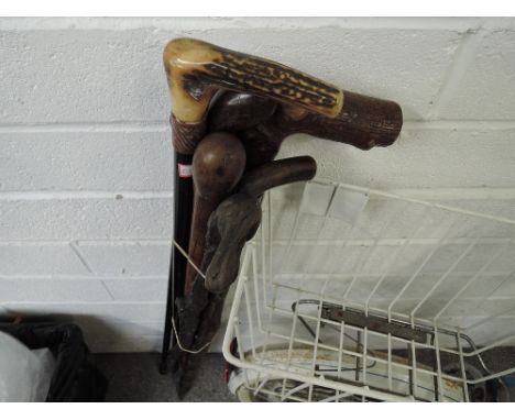 A selection of hiking walking fishing hunting sticks and canes