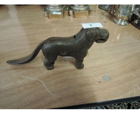 A vintage cast iron nut cracker in the form of a dog