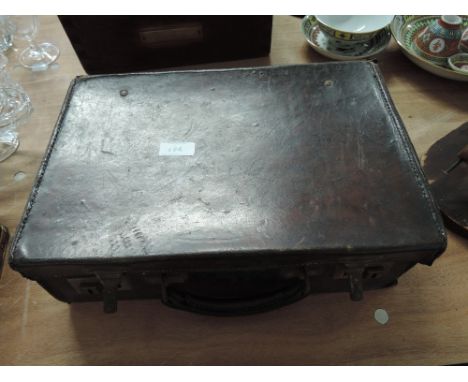 A vintage childrens leather and brass clasp suitcase travel trunk  similar to Paddington Bears