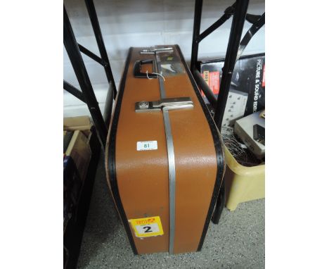 A vintage travel trunk suitcase brown leather with black trim and steel clasps