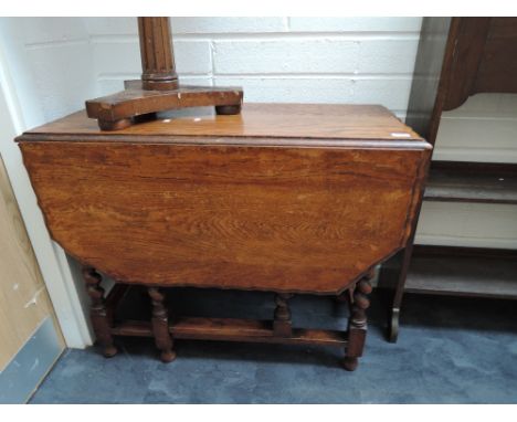An early to mid 20th Century oak twist gate-leg dining table
