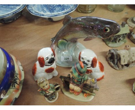 A selection of vintage ceramic figures including Goebel, leaping trout, and miniature dog pair