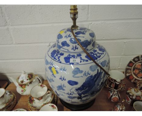 A floor standing lamp in the shape of a large oriental ginger jar with dragon decoration