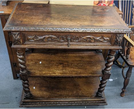 A late 19th century oak three-tier buffet stand having scroll work moulding, single drawer and barley twist supports 98.5cm h