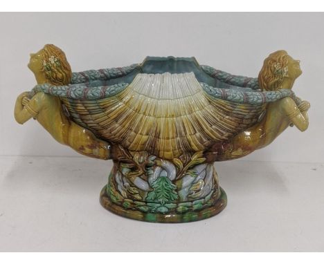 A late 19th century Majolica planter jardinière fashioned as a shell flanked by nude maidens, on a pedestal oval base, 32cm h