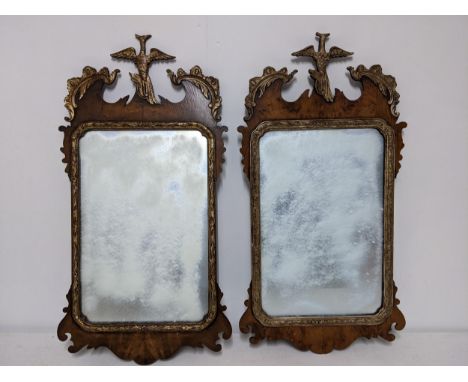 A pair of 20th Century Chippendale style parcel-gilt, walnut mirrors surmounted by a bird foliage and fretworked ornament, 76