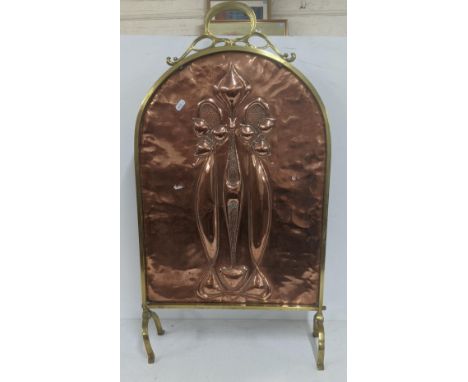 An Art Nouveau copper and brass fire screen with oval top, embossed with a floral design, 81cm x 46cm w A/F, together with a 