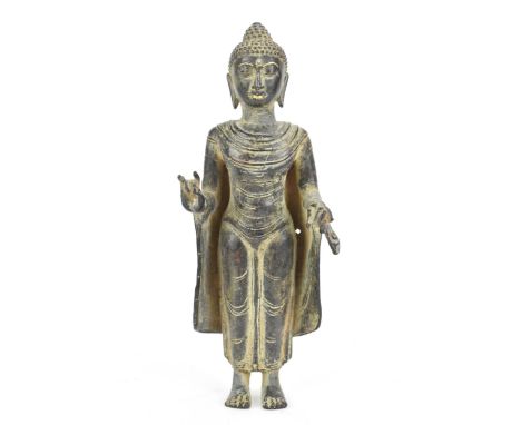 A Cambodian Khmer bronze figure of a Buddha, in a standing Mudra position, wearing elegant monastic robes,17.5cm high x 6.5cm