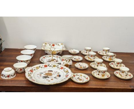 A Royal Crown Derby tea service decorated in the Imari pattern to include cups and saucers, bowls, fruit bowl, large dish and