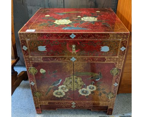 An Asari red lacquered side cabinet, single drawer over twin cupboard doors, decorated with birds, 61cm x 50.5cm x 41cm, toge