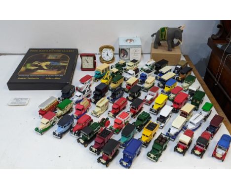 A mixed lot to include two travel clocks, a collection of Lledo Days Gone and Oxford die cast model vehicles, a Harrods Steif