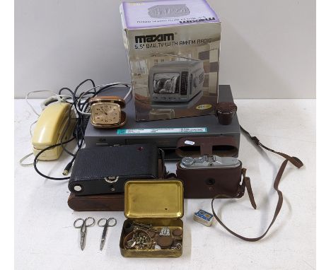A mixed lot to include a boxed Maxim 5.5" black and white TV with FM radio, a coral travel alarm clock, two vintage cameras a