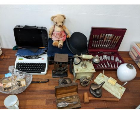 A mixed lot to include a typewriter, scales, commemorative collectables, a stool, a canteen of cutlery, a bowler hat, ceramic