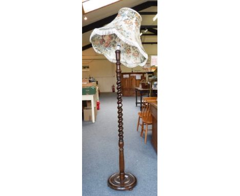 An oak barley-twist stem standard lamp, with floral fringed shade 