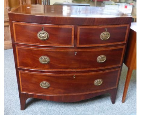 A Georgian cross-banded mahogany bow-fronted chest of 2 short and 2 long graduated drawers on splayed feet, 87cm wide