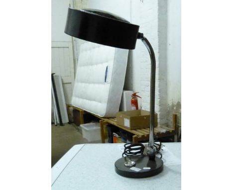 A chrome stand desk lamp