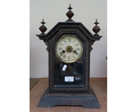 An oak cased mantel clock