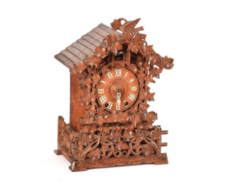 CARVED OAK CASED CUCKOO CLOCK WITH CIRCULAR DIAL OF 5 INCHES AND A DOUBLE FUSEE MOVEMENT. HEIGHT: 18 INCHES.WIDTH: 12 INCHES.