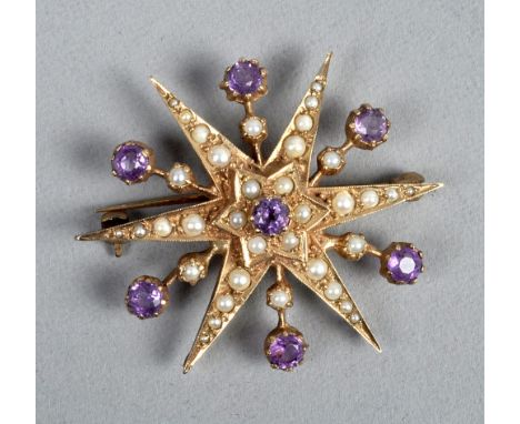An Edwardian gold seed pearl and amethyst set star brooch. 