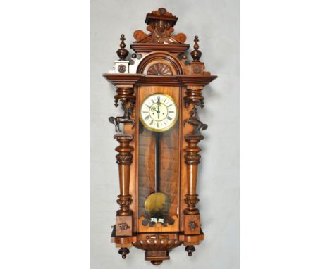 A late 19c German two weight Vienna regulator by Gustav Becker, the large and ornate walnut case having a double cresting wit