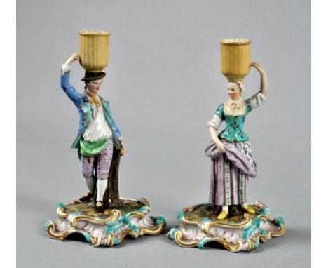 A pair of Meissen candlestick figures in the form of harvesters, each on a rococo scrolling base, 8.25"h. 