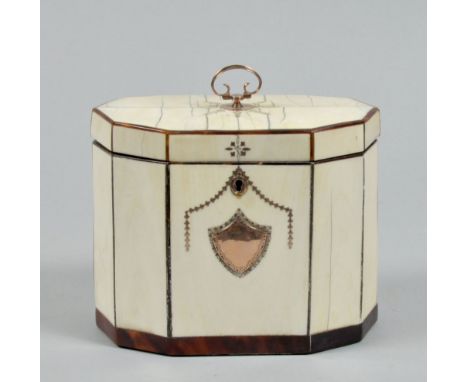 A George III ivory two compartment tea caddy of decagonal form, with gold and mother of pearl swag and shield decoration with