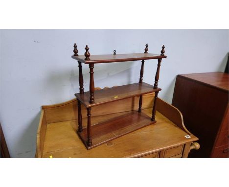 A mahogany three tier shelf. 52cm wide