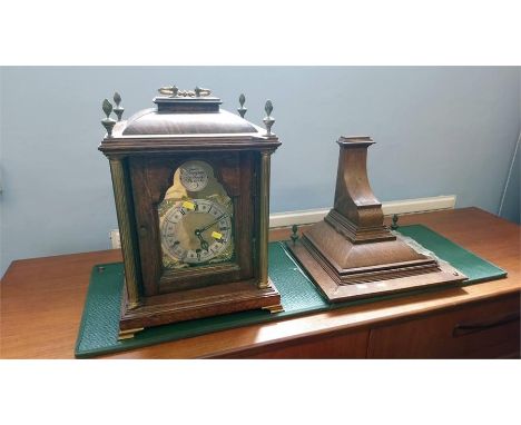 An oak case 'Tempus Fugite' bracket clock with eight day movement, strike action, silvered chapter ring and wall bracket