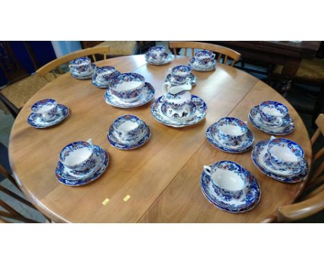 A Victorian Imari pattern tea service, comprising 12 cups and 12 saucers, 12 side plates , 2 cake plates , 2 bowls and a crea