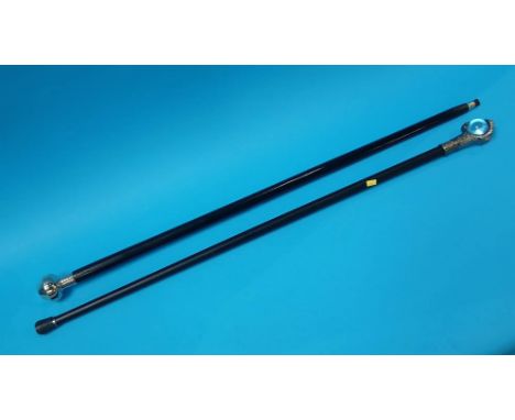 Two walking canes, one with compass in handle