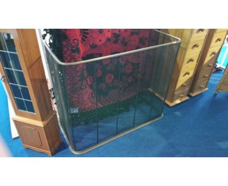 A late 19th Century brass and wirework fireguard