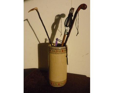 Ceramic stick stand with vintage shooting stick and two walking sticks 