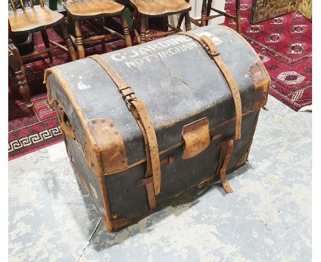 Domed top leather and canvas trunk with painted inscription to top ' G Jardine Nottingham' on wooden runners with metal wheel